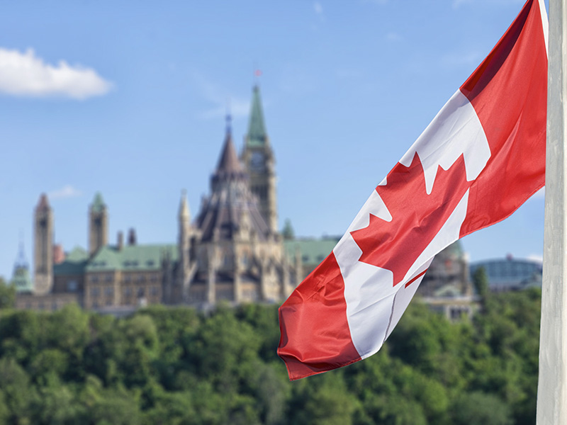 Drapeau du canada flottant devant le parlement, à Ottawa.