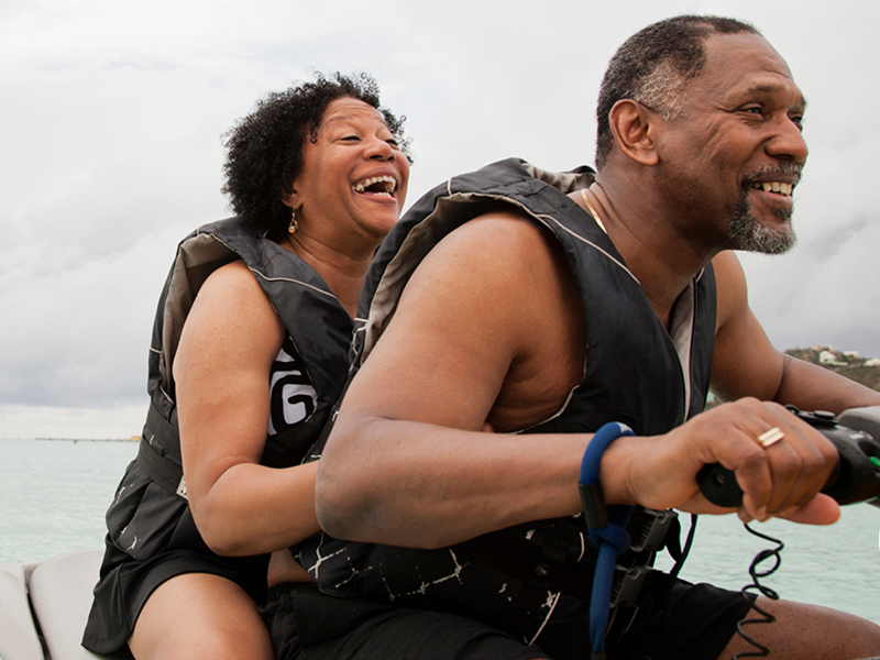 A man and woman riding a jet ski